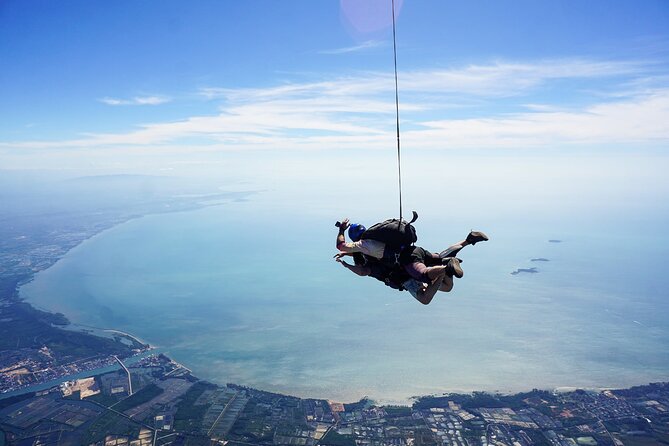 First Jump Tandem Skydive Pattaya Include Pickup Transfer - Landing on grass and celebrating with friends and family